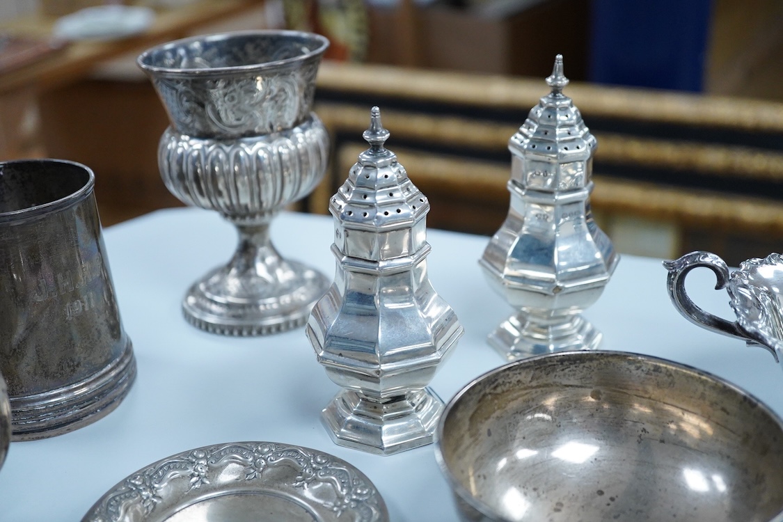 A collection of small silver wares to include a George V silver porringer, two George V silver sauce boats, a let Victorian silver sugar bowl, a George III silver goblet, with later embossed decoration, a George V small